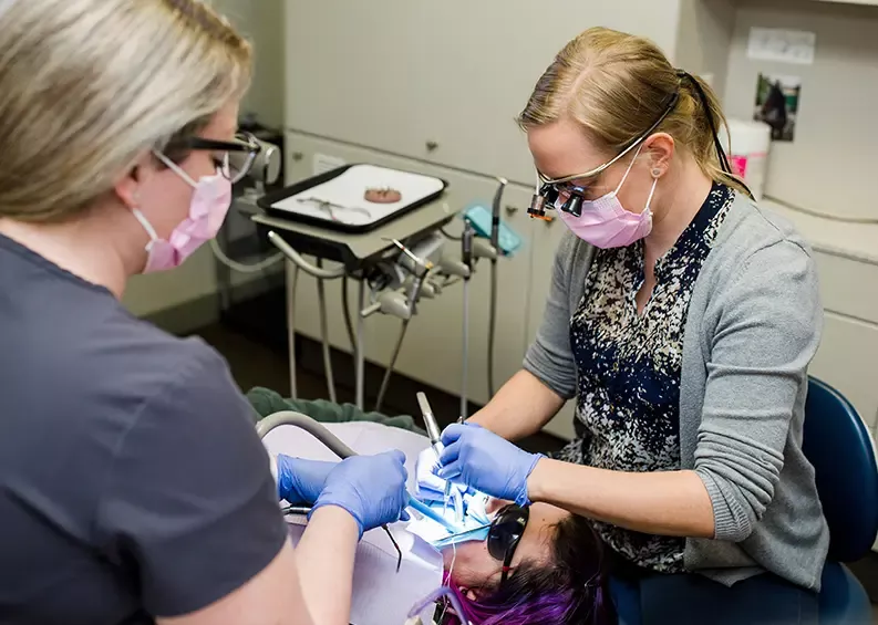 Performing dental cleaning on patient