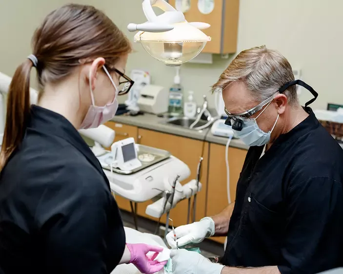 Performing dental exam on patient